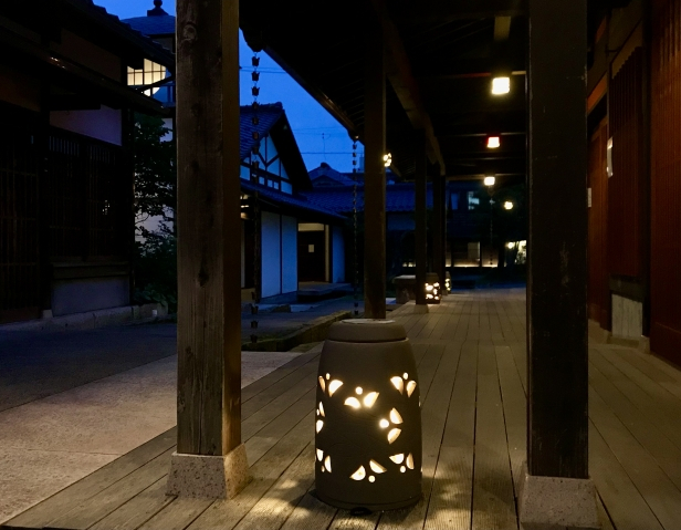 A traditional Japanese veranda with lantern light on a summer night, capturing the quiet beauty of old Japan.